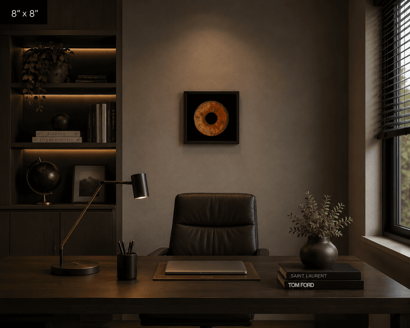 Framed brown iris artwork centered on a wall above a dark wood office desk.